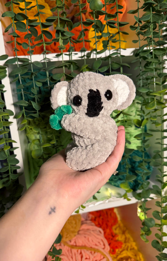 Baby Koala Holding Eucalyptus Leaf