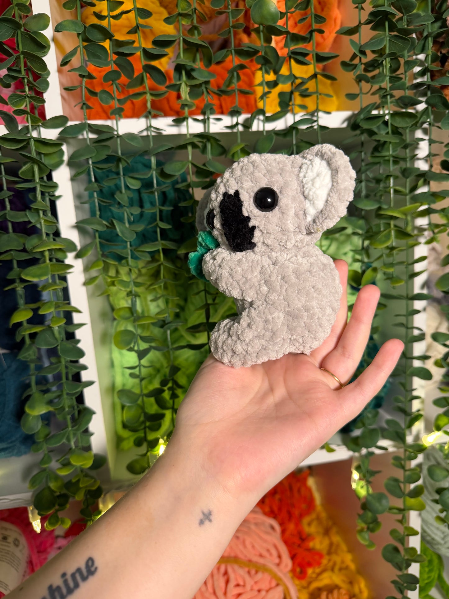 Baby Koala Holding Eucalyptus Leaf