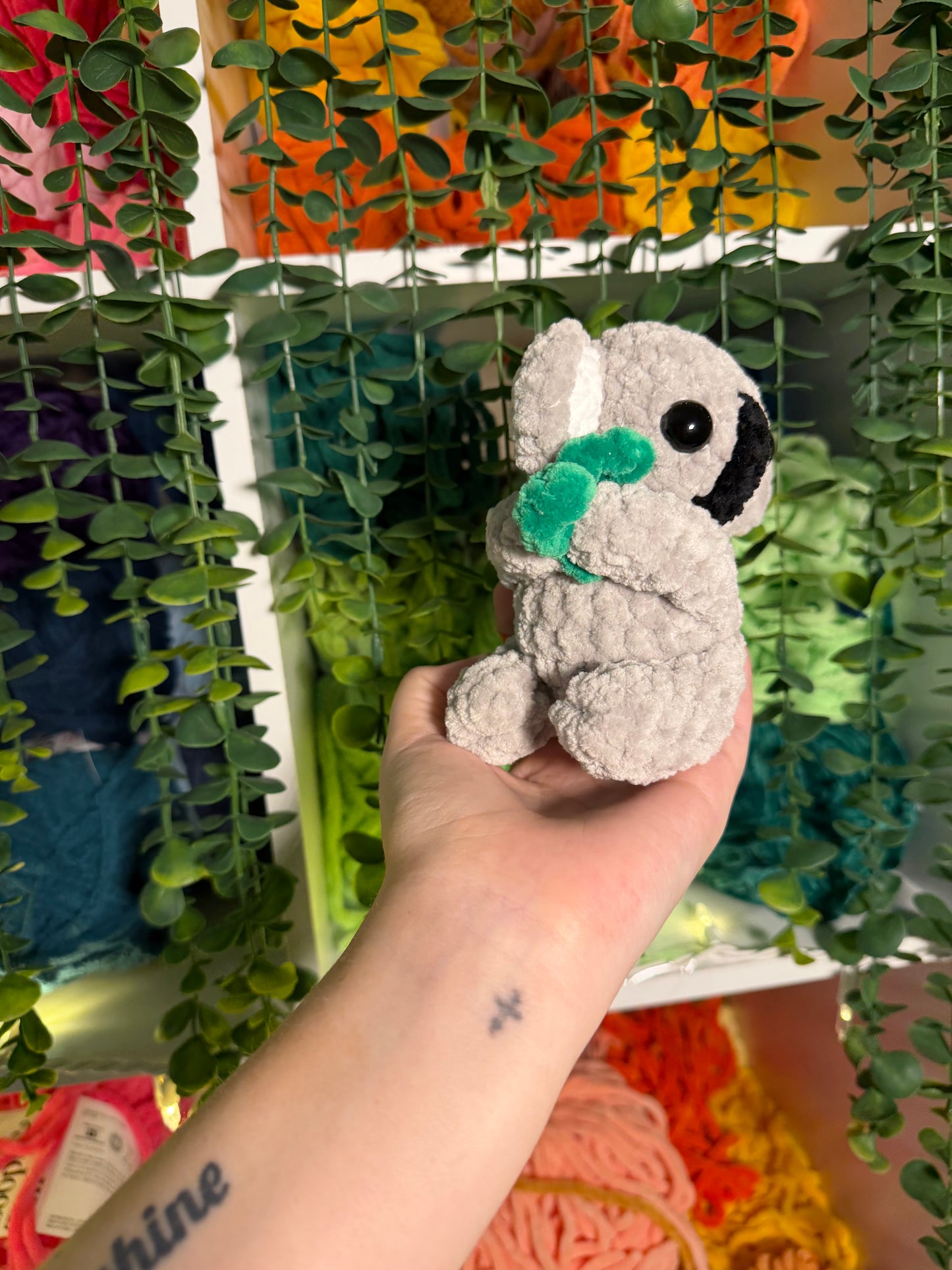Baby Koala Holding Eucalyptus Leaf