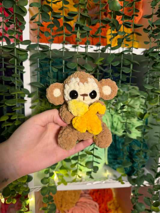Baby Monkey Holding Banana